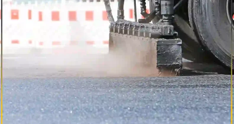 Road construction machinery spraying a prime coat highlighting the practical application differences between bitumen emulsion and cutback bitumen