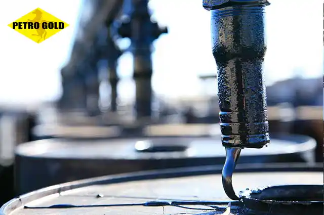 Viscous liquid bitumen filling steel drums at a refinery showcasing the optimal physical properties suitable for industrial use