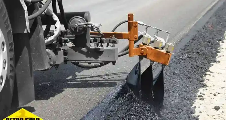 Road construction machinery spraying emulsion bitumen on asphalt surface demonstrating the practical application of the product