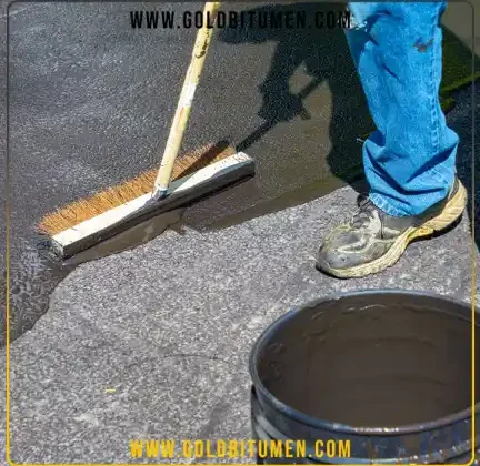 Worker applying blacktop sealer on a driveway illustrating the practical difference between blacktop and asphalt surfaces